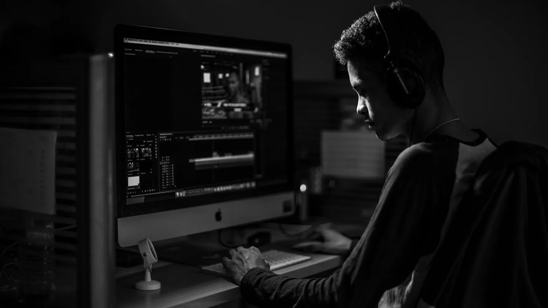 A founder working with live data dashboards and AI-powered analytics in a cinematic dark office